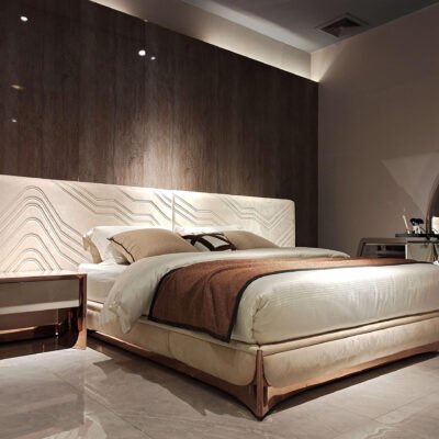 Exquisite Lumina White Leather Bed with white fabric headboard and rose gold hardware.