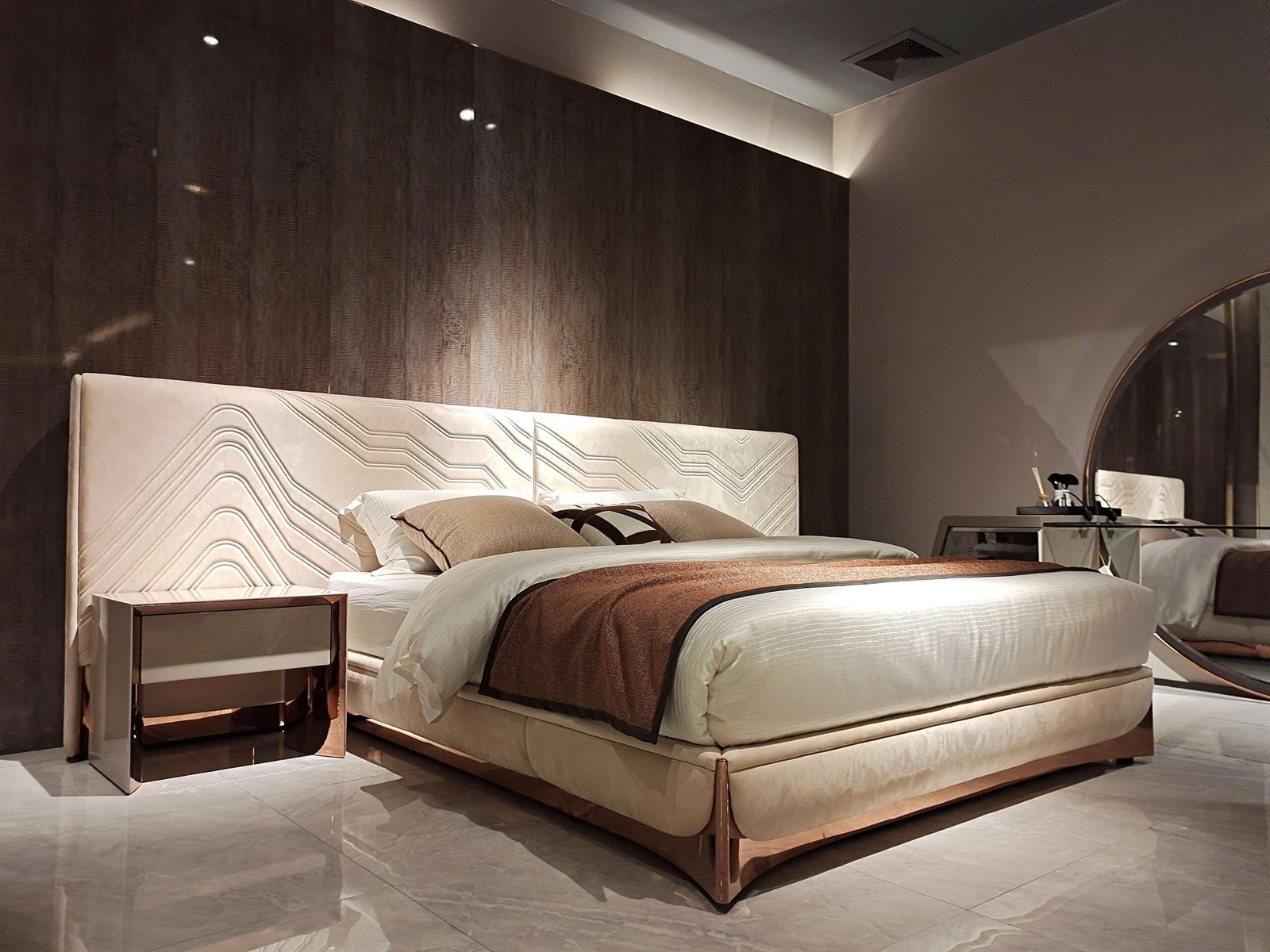 Exquisite Lumina White Leather Bed with white fabric headboard and rose gold hardware.