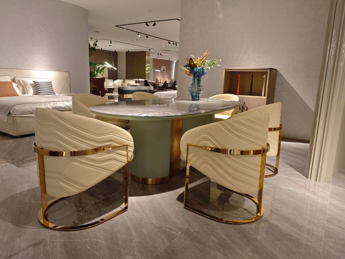 Premium natural stone dining furniture in upscale restaurant with guests seated around oval marble table