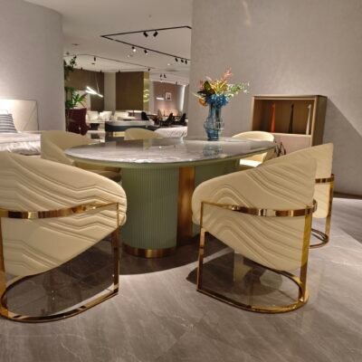 Premium natural stone dining furniture in upscale restaurant with guests seated around oval marble table