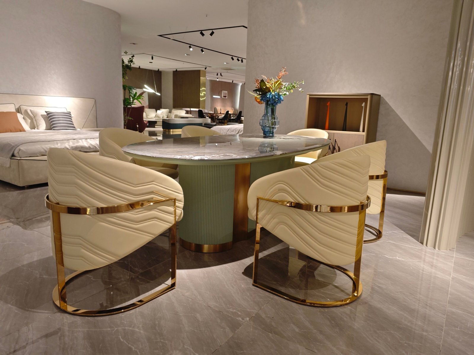 Premium natural stone dining furniture in upscale restaurant with guests seated around oval marble table