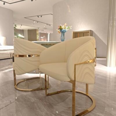 Contemporary gold accent chair in modern restaurant dining room with commercial restaurant chair arrangement