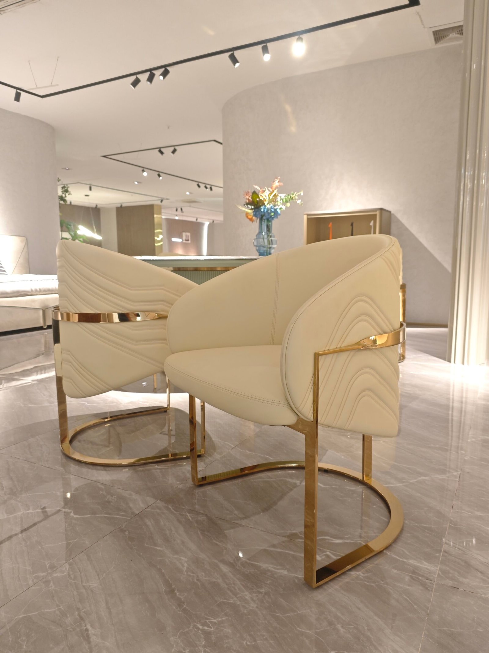 Contemporary gold accent chair in modern restaurant dining room with commercial restaurant chair arrangement