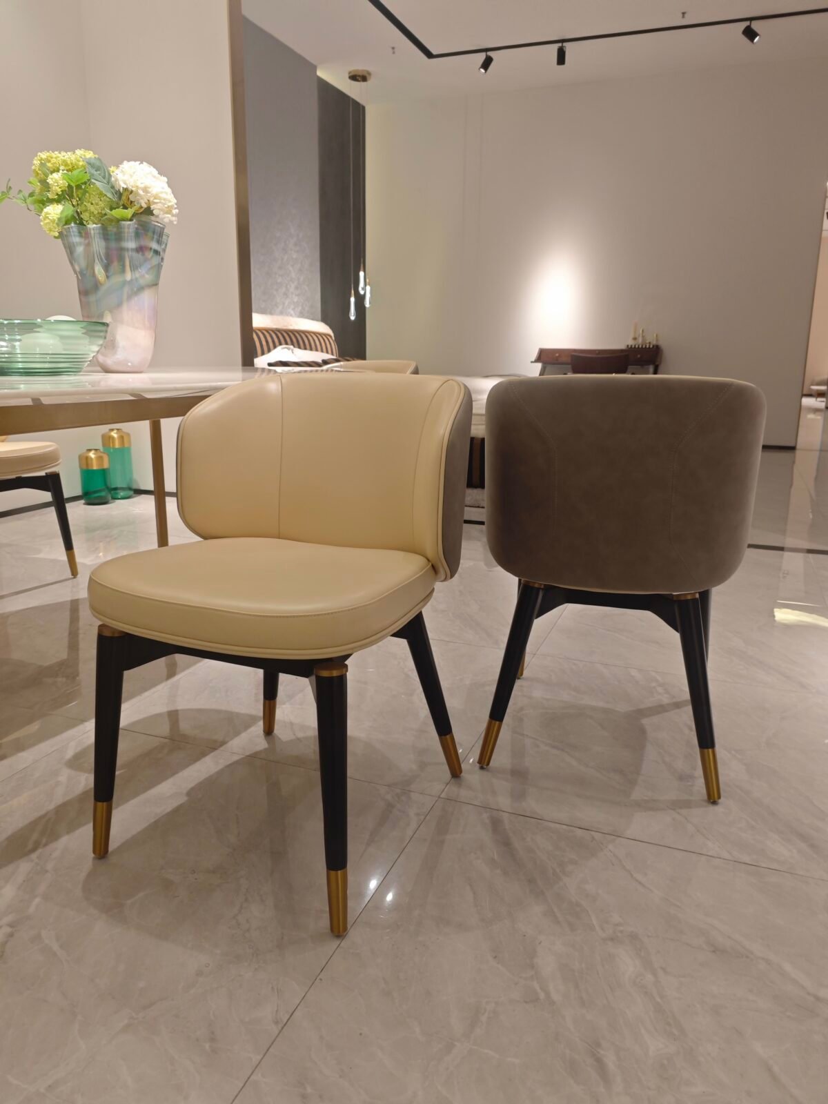 Two-tone upholstered dining chair genuine leather beige upholstery black frame detail close-up