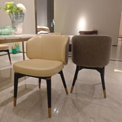 Two-tone upholstered dining chair genuine leather beige upholstery black frame detail close-up