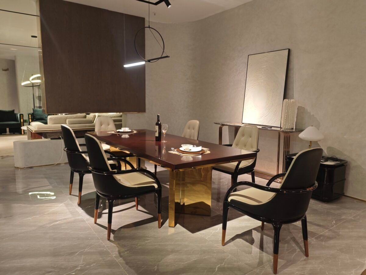 Contemporary statement dining table in luxury dining room with bronze pedestal base and geometric inlay