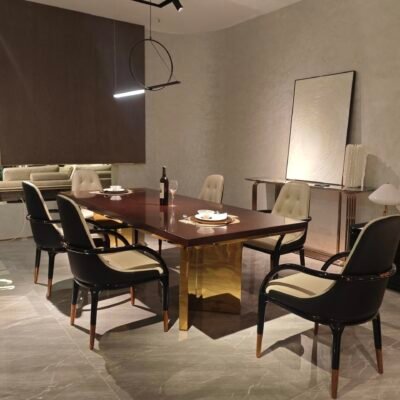 Contemporary statement dining table in luxury dining room with bronze pedestal base and geometric inlay