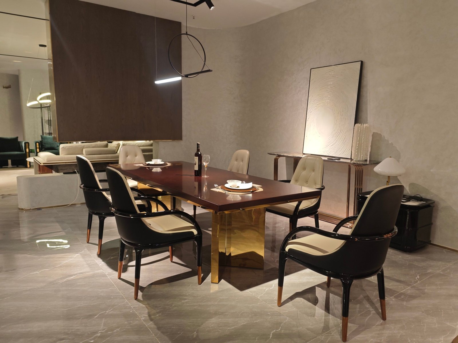 Contemporary statement dining table in luxury dining room with bronze pedestal base and geometric inlay