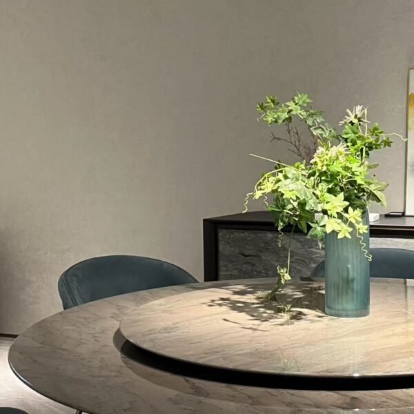 Close-up of Tianshan snow stone surface with natural veining and smoked glass turntable on luxury table