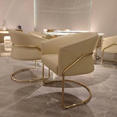 Contemporary dining chair metal legs brushed gold hardware genuine leather upholstery detail