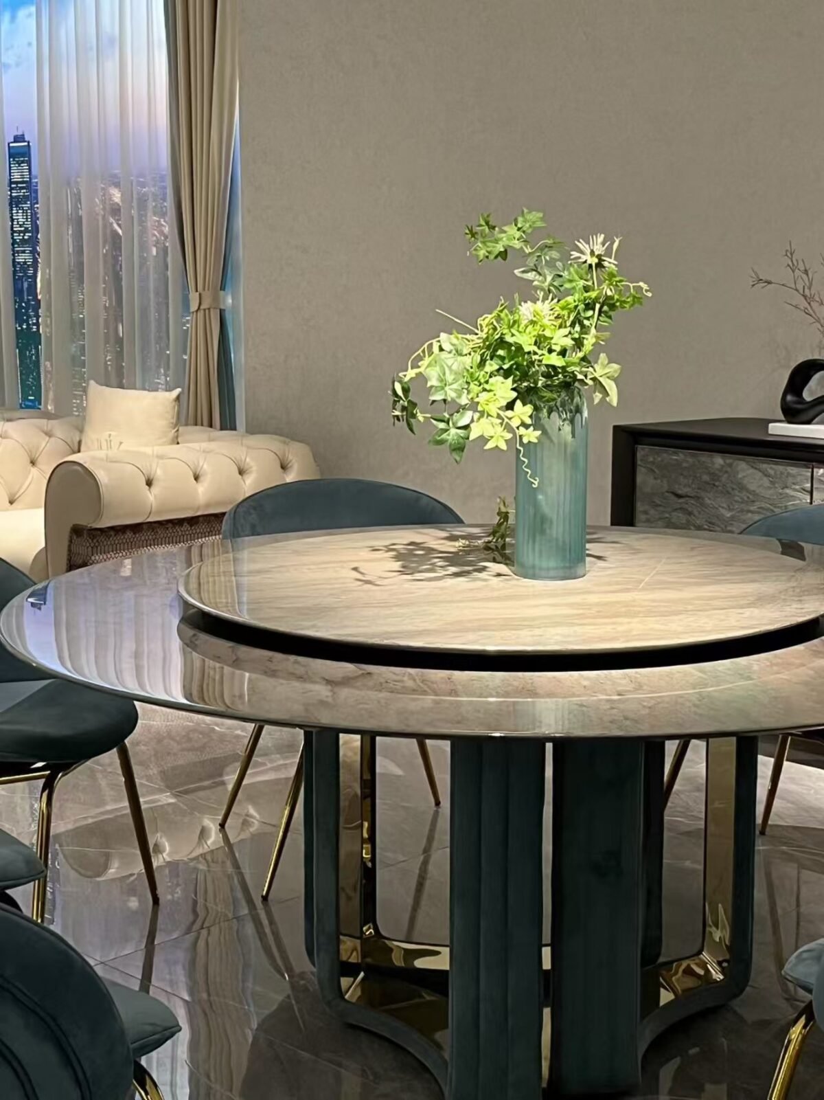 Close-up of Tianshan snow stone surface with natural veining and smoked glass turntable on luxury table