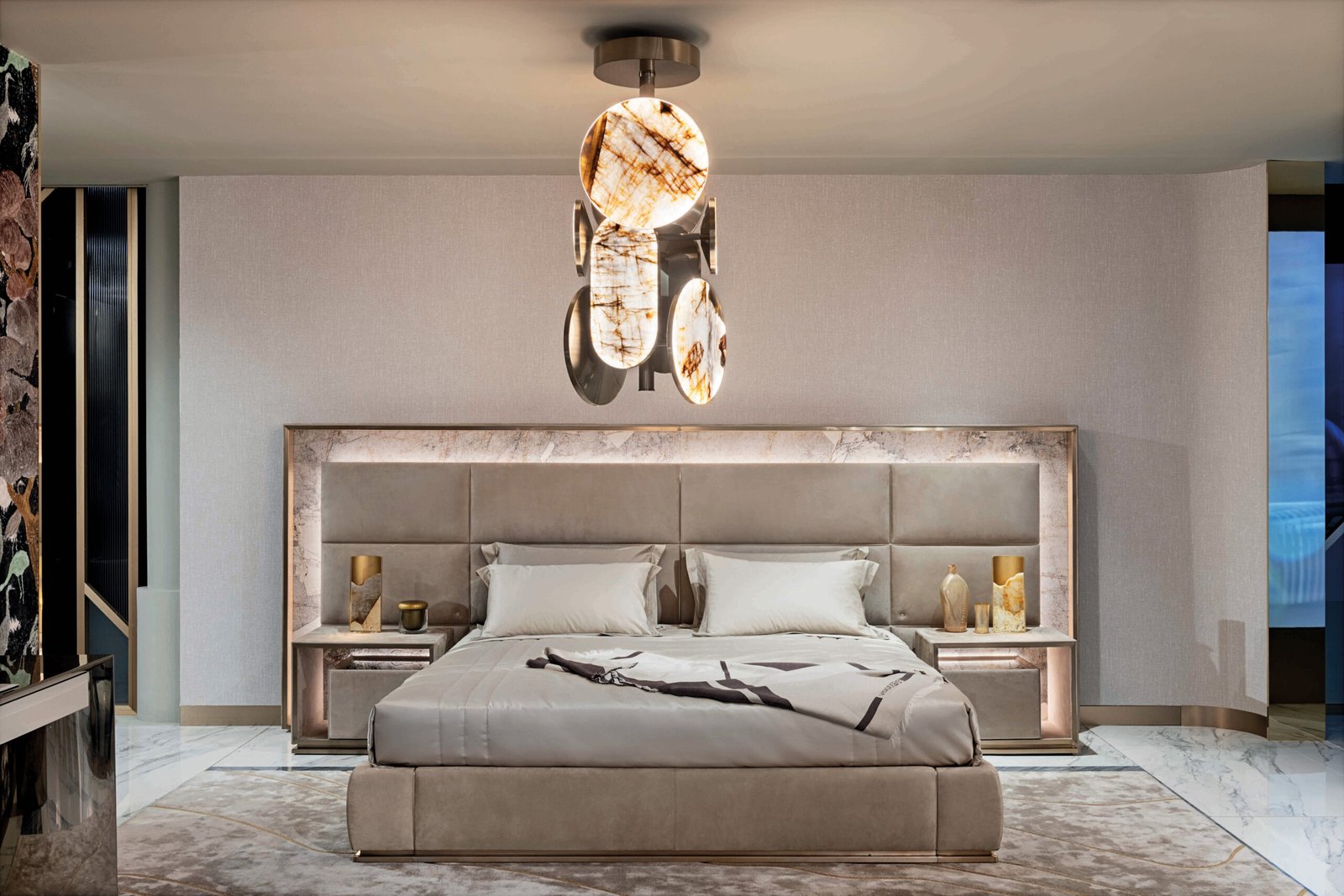 Luxury bed with gold headboard and smart lighting in modern bedroom with matching nightstand