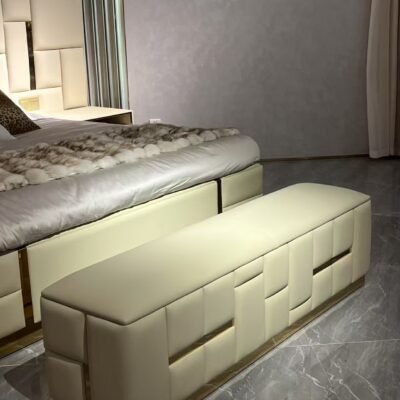 Babylon bedend stool brushed brass with cream channel tufting and architectural metallic base