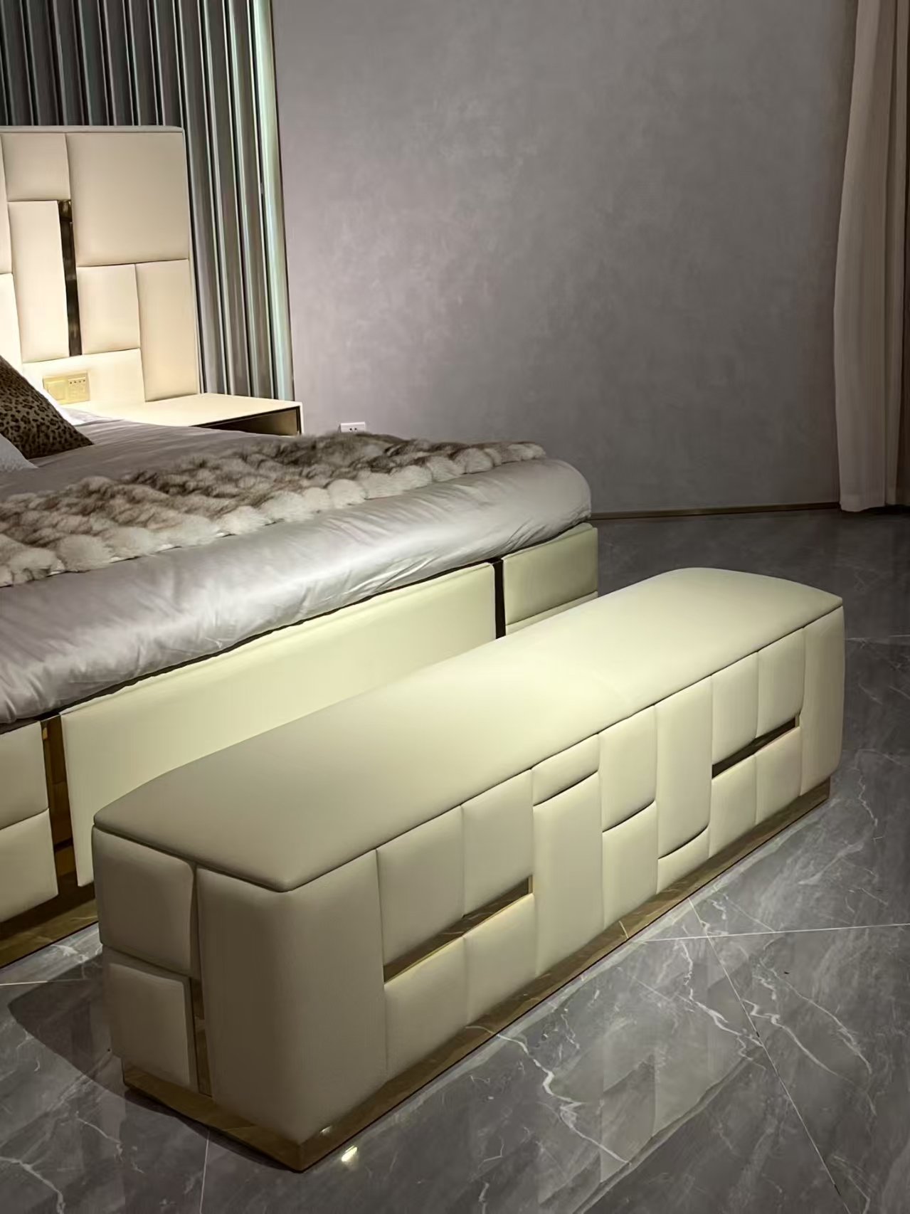 Babylon bedend stool brushed brass with cream channel tufting and architectural metallic base