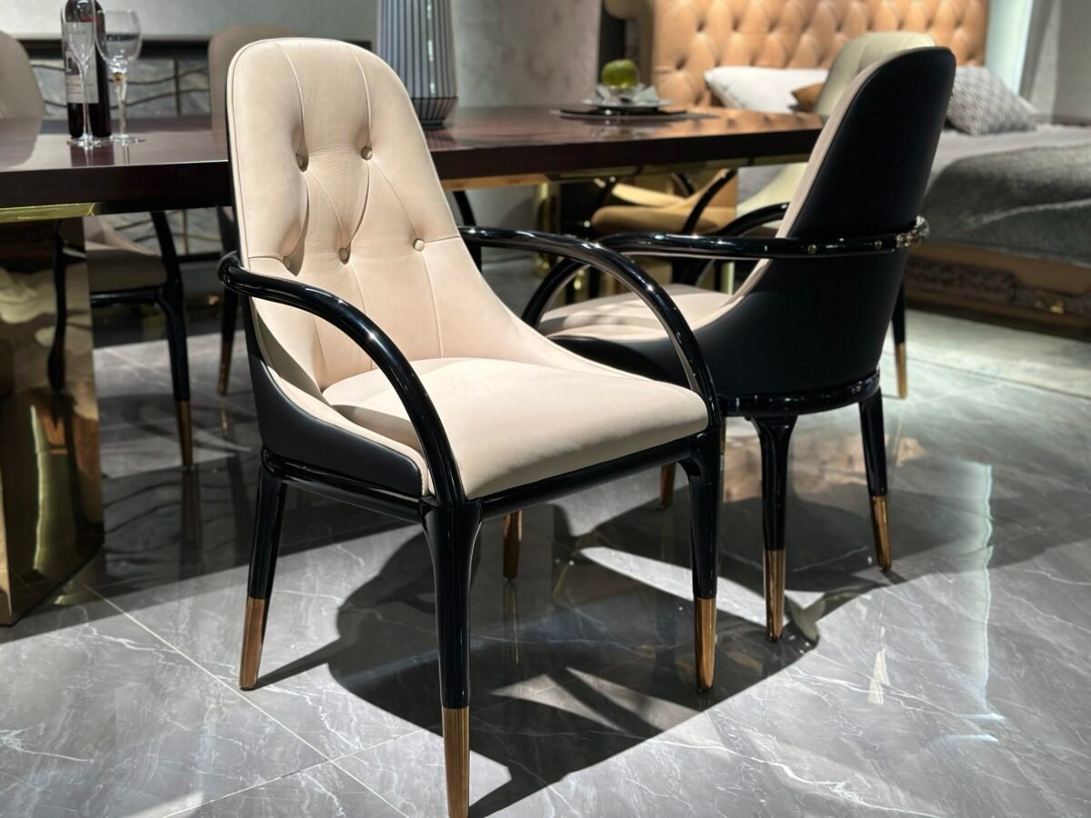 Contemporary upholstered dining chair detail showing velvet texture rose gold hardware and lacquer finish