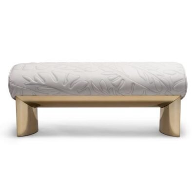 Bedend stool with brushed gold finish featuring quilted frosted cloth upholstery and curved legs