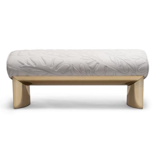 Bedend stool with brushed gold finish featuring quilted frosted cloth upholstery and curved legs
