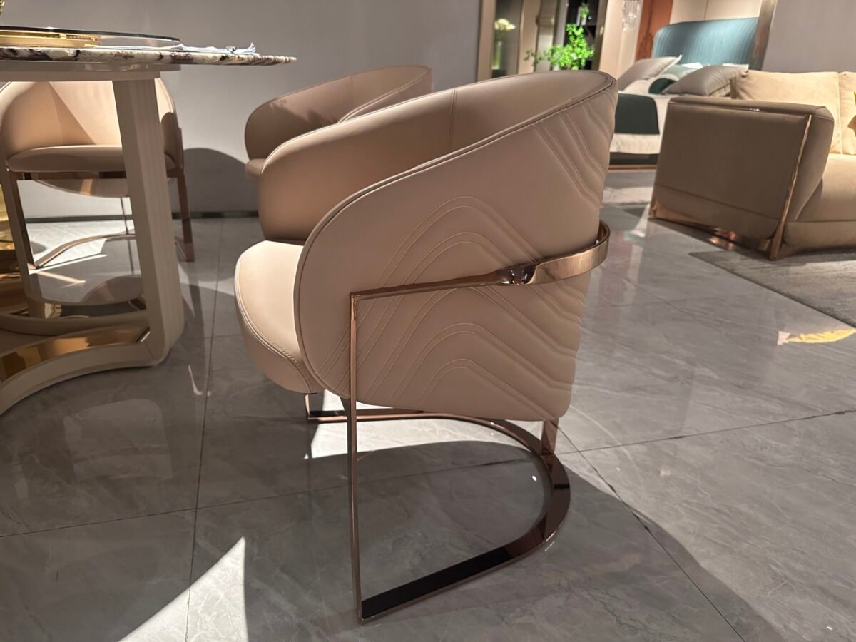 Luxury leather dining seating detail showing beige leather texture gold leg finish close-up