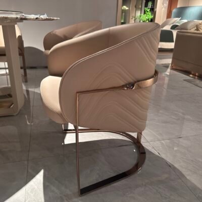 Luxury leather dining seating detail showing beige leather texture gold leg finish close-up