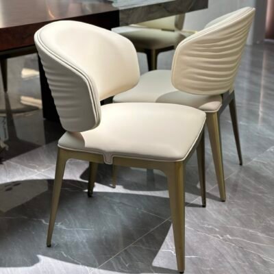 Titanium finish dining chair detail showing brushed metal texture leather upholstery close-up