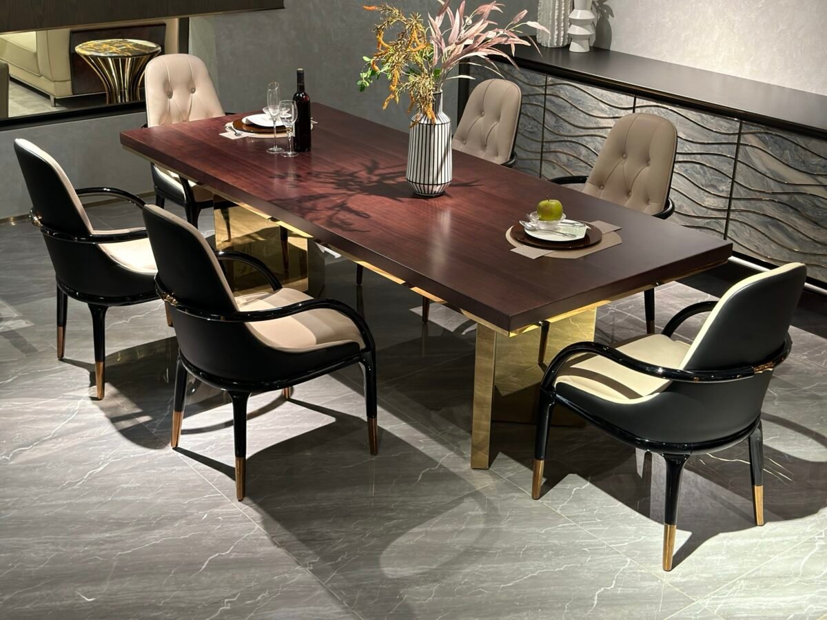 Contemporary statement dining table in luxury dining room with bronze pedestal base and geometric inlay