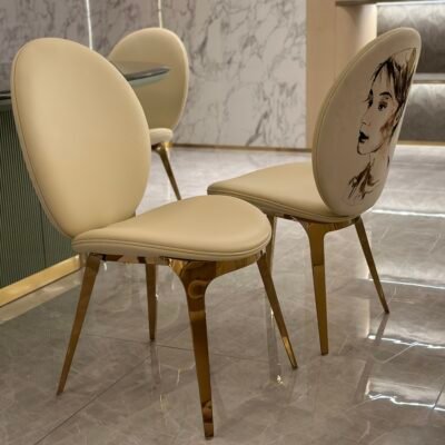 Luxury upholstered dining chair brushed gold metal detail white leather upholstery close-up