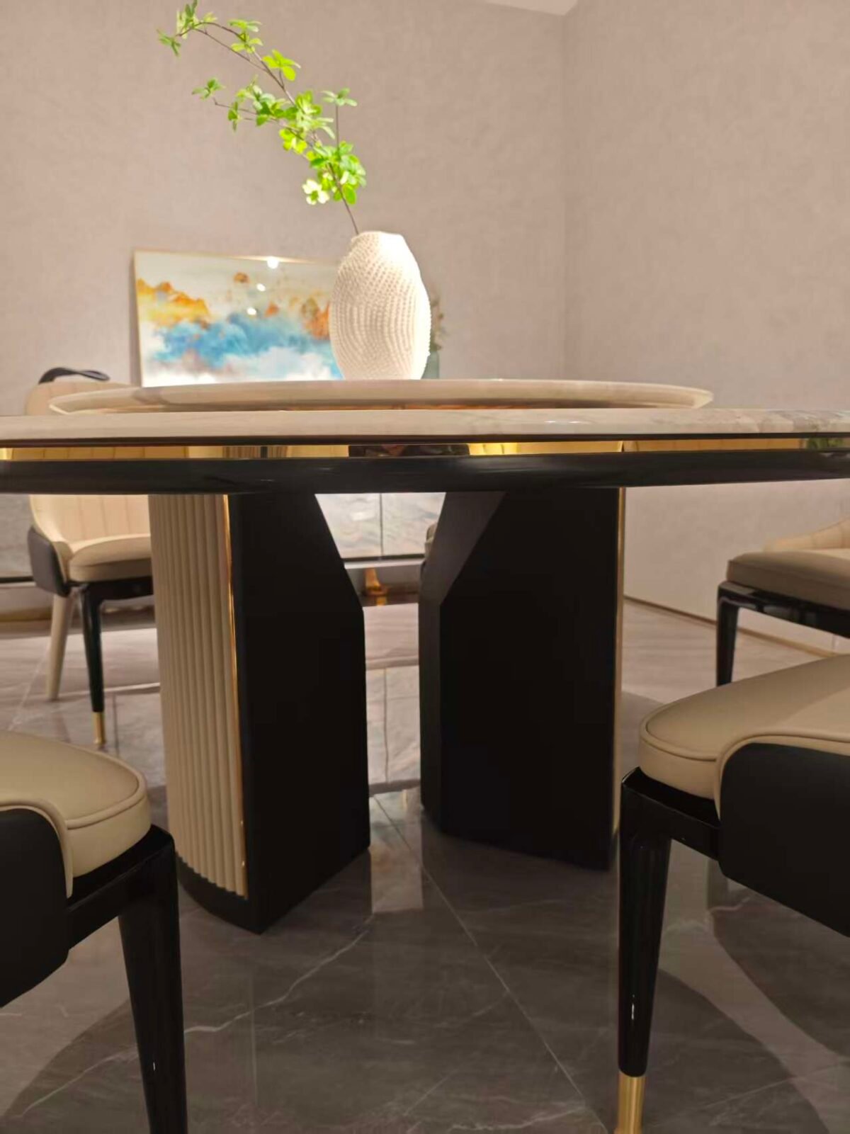 Luxury rotating dining table detail showing Picasso stone veining and turntable mechanism close-up