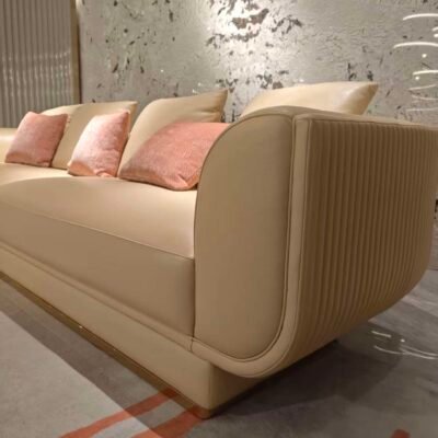 Close-up beige genuine leather modular sofa upholstery texture and 3cm metal leg construction detail