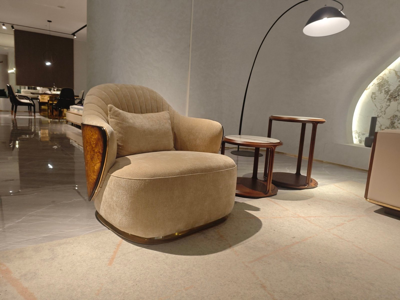 Beige leather lounge chair boutique hotel suite bedroom interior luxury neutral furniture hospitality design contemporary residential sophisticated