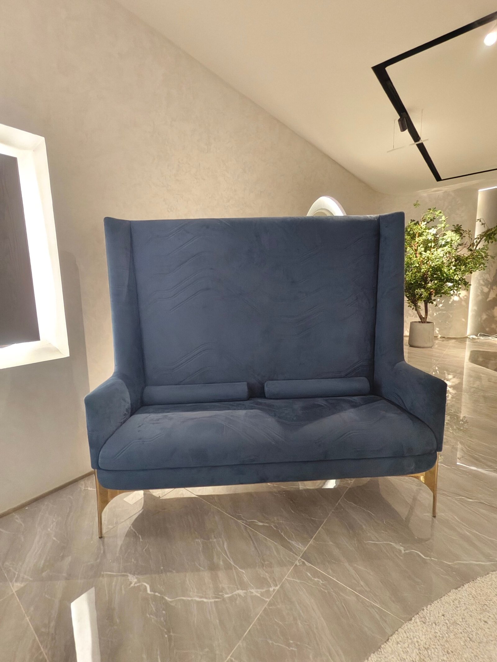 High back velvet armchair boutique hotel lobby interior luxury statement furniture hospitality design blue gold contemporary spac