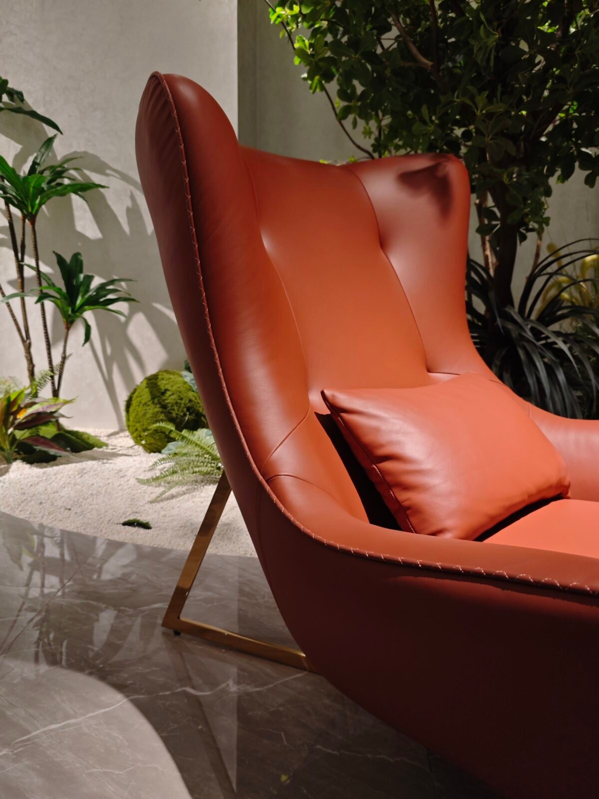 Brown leather upholstery close up texture grain recliner mechanism detail hardware construction commercial hospitality furniture craftsmanship