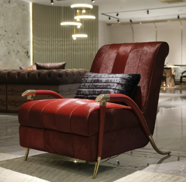 Red leather armchair boutique hotel lobby interior luxury statement furniture bold design hospitality gold legs contemporary dramatic space