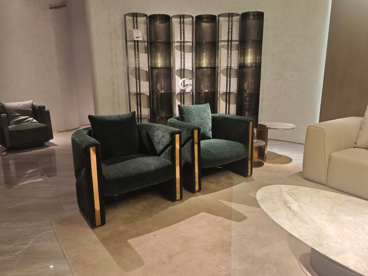 Green velvet accent chair boutique hotel bedroom interior luxury furniture hospitality design gold trim contemporary glamour setting.