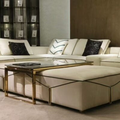 Luxury ottoman footrest in frosted cloth fabric with square silhouette styled in white and gold living room
