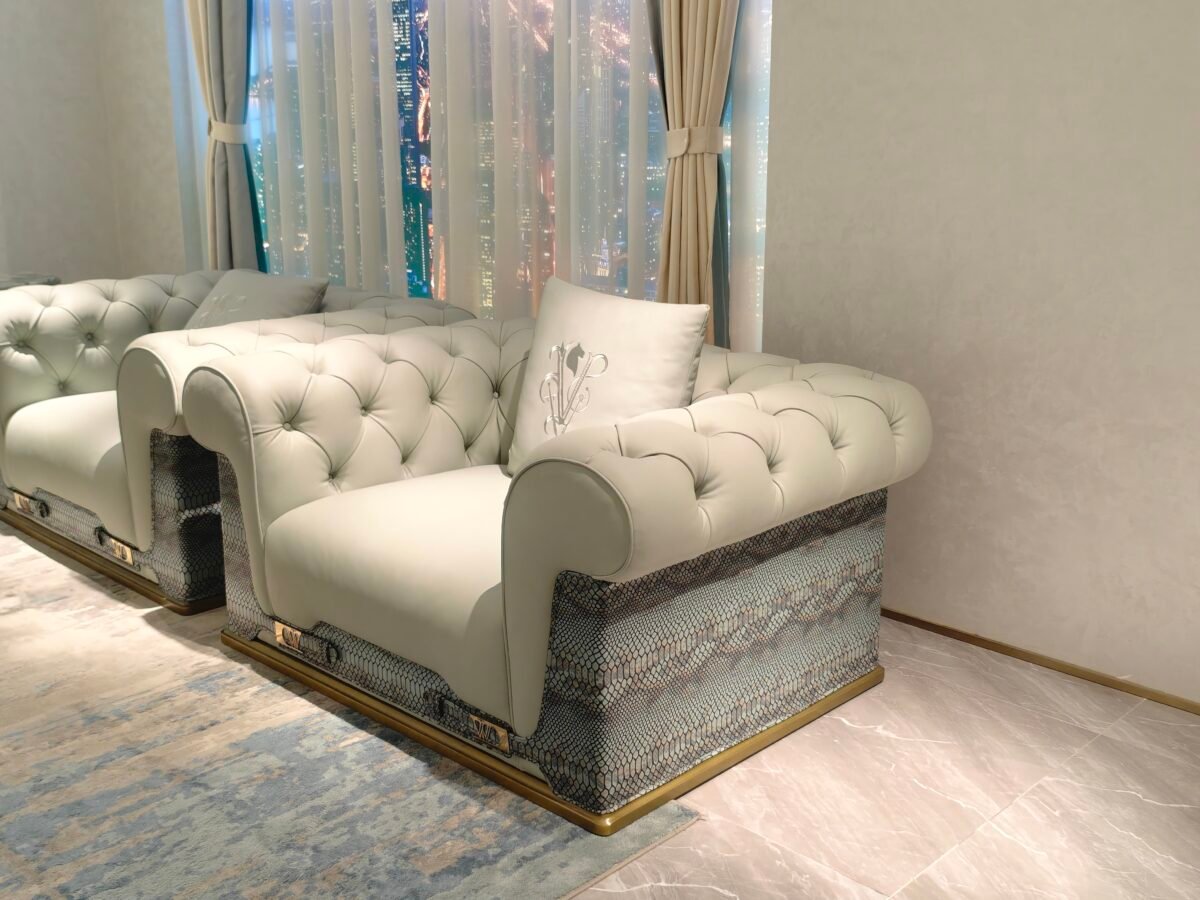 Statement sofa with blue accent pillow in contemporary luxury living room interior