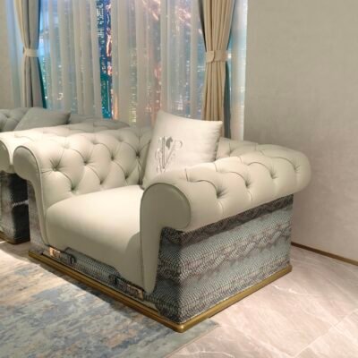 Statement sofa with blue accent pillow in contemporary luxury living room interior