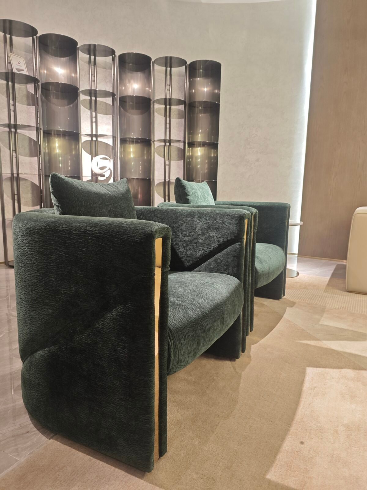 Green velvet upholstery close up gold trim detail wooden frame joinery commercial hospitality furniture craftsmanship texture pile