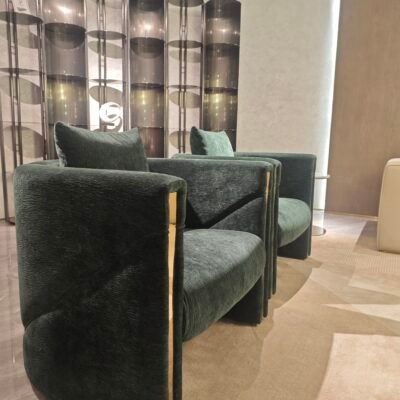 Green velvet upholstery close up gold trim detail wooden frame joinery commercial hospitality furniture craftsmanship texture pile