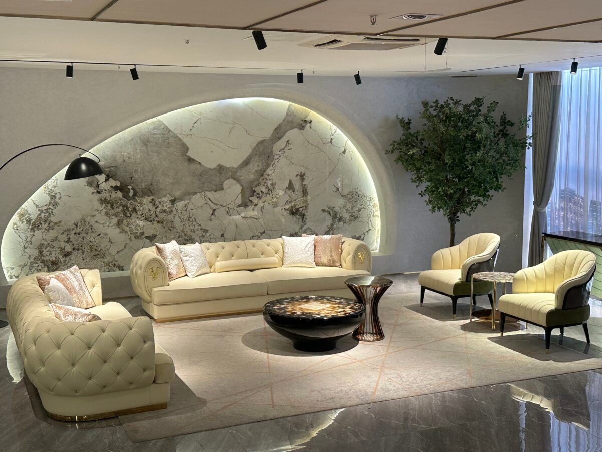 White leather sofa gold trim boutique hotel presidential suite interior luxury furniture pristine hospitality design contemporary residential opulent