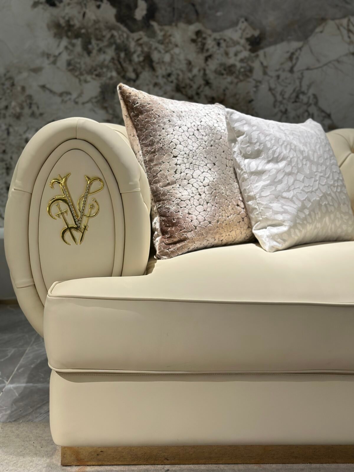 White genuine leather close up texture gold brass trim detail pristine upholstery commercial hospitality furniture craftsmanship quality hardware