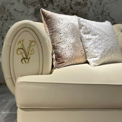 White genuine leather close up texture gold brass trim detail pristine upholstery commercial hospitality furniture craftsmanship quality hardware