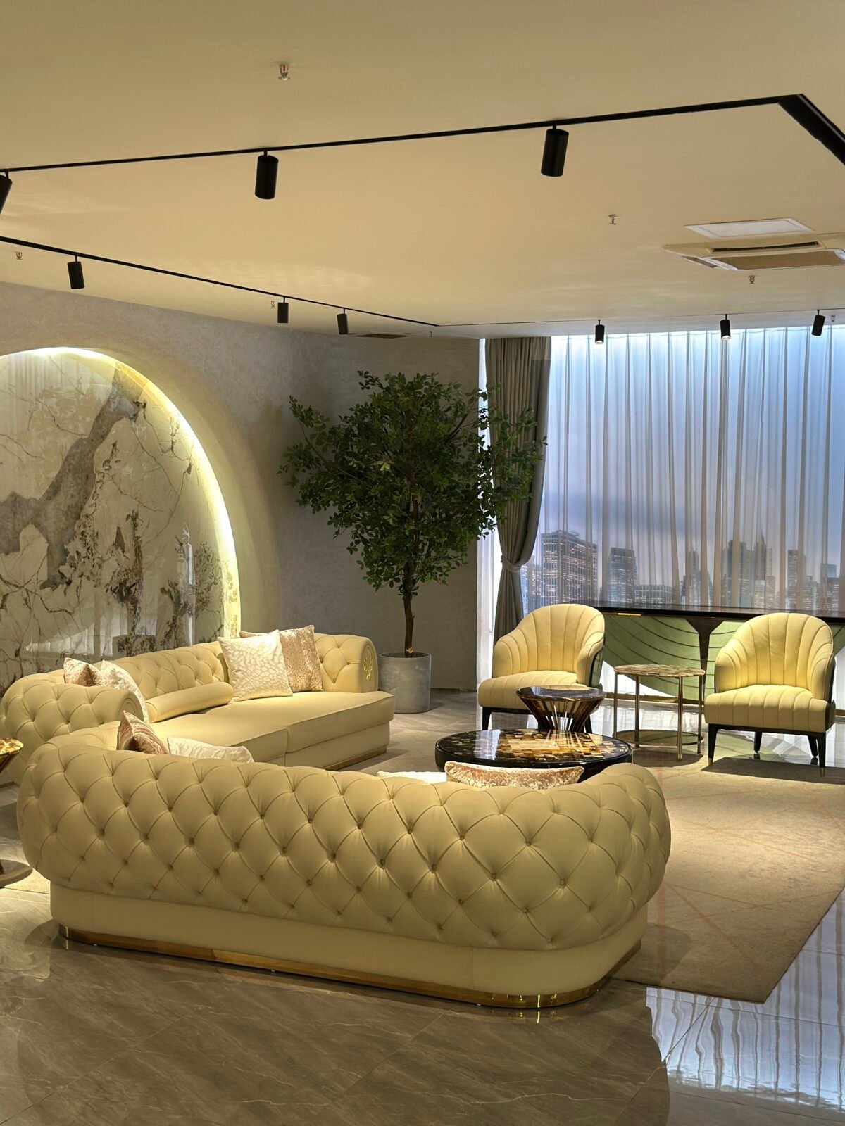 White leather sofa gold trim boutique hotel presidential suite interior luxury furniture pristine hospitality design contemporary residential opulent