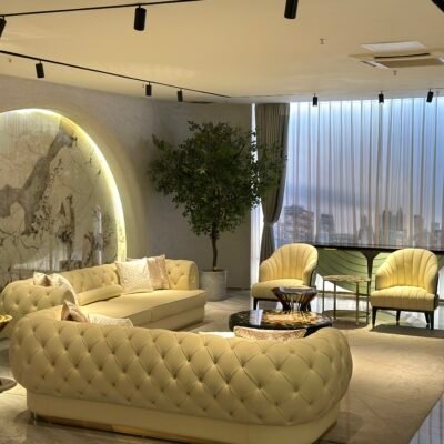 White leather sofa gold trim boutique hotel presidential suite interior luxury furniture pristine hospitality design contemporary residential opulent