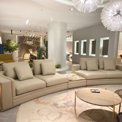 Luxury stone accent modern curved sofa styled in contemporary luxury living room interior