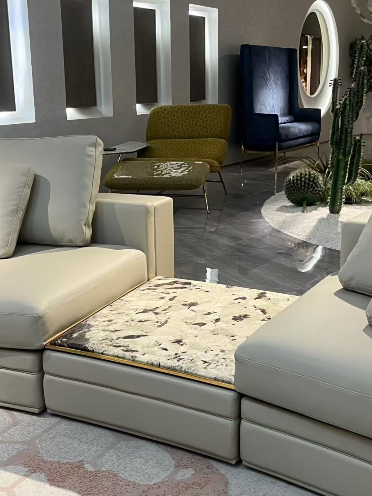 Close-up Tianshan Muxue stone accent and genuine leather surface texture on curved Babylon sofa