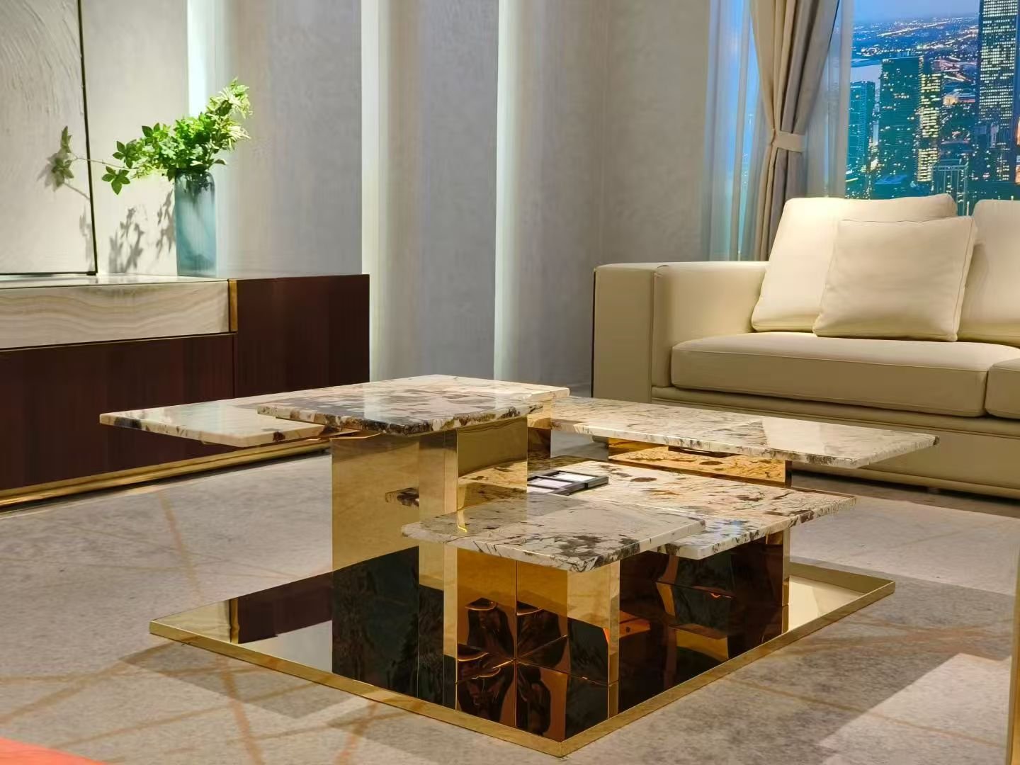 Contemporary elevated stone coffee table for living room office styled in modern residential professional interior titanium gold pedestal
