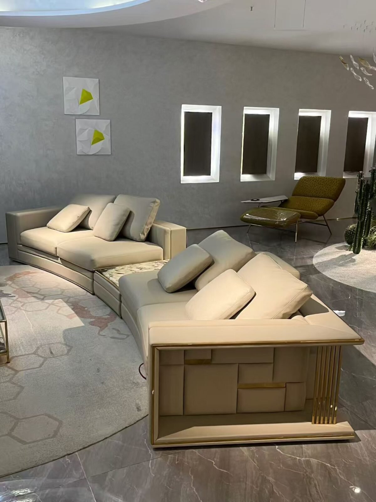 Close-up Tianshan Muxue stone accent and genuine leather surface texture on curved Babylon sofa