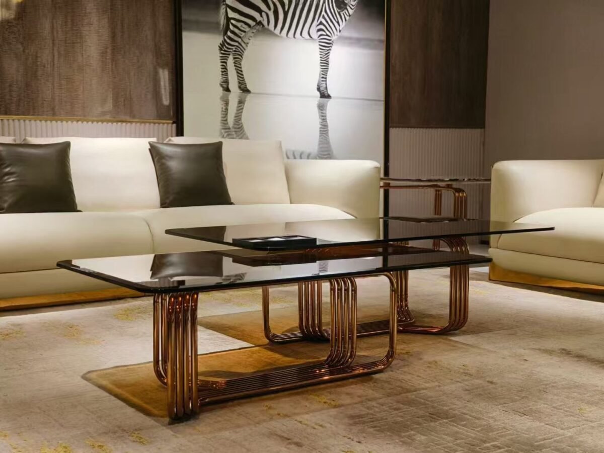Metal base amber glass lounge coffee table styled in contemporary luxury living room interior