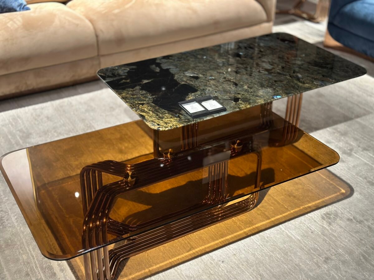 Close-up platinum diamond accent glass living room table surface and copper top finish detail