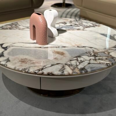 Close-up gray marble coffee table gold base natural stone surface pattern and hardware detail